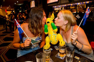 Girls kissing a blow up kangaroo with Australia flags on gold coast pub crawl on Australia day pub crawl with Down Under