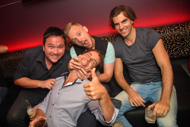 four guys having fun in the clubs at their birthday party