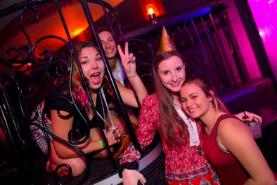 four group of girls in the clubs one wearing a party hat