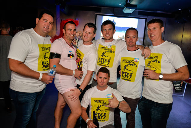 a group of boys with Bucks party t-shirts and the stag dressed as a female
