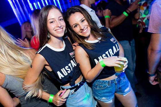 Smiling girls in Australia shirts in Asylum nightclub in Surfers Paradise with the Down Under Party Tour