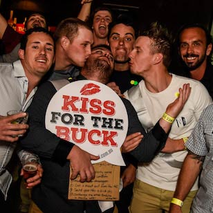 Bucks party holding kiss for the buck sign on surfers paradise nightlife tour down under