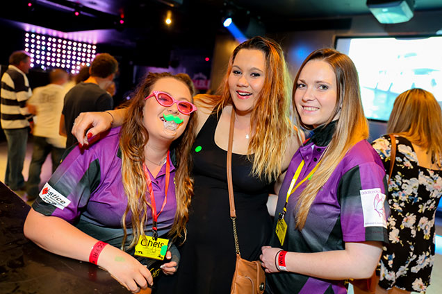 group of netball footy team trip dressed in purple teams shirt